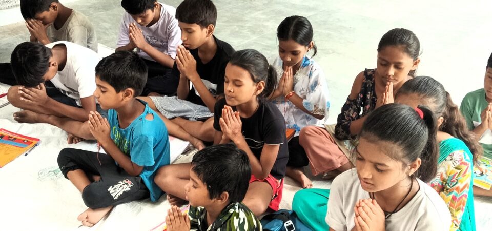 a group of children praying